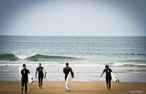 Men in black going to surf
